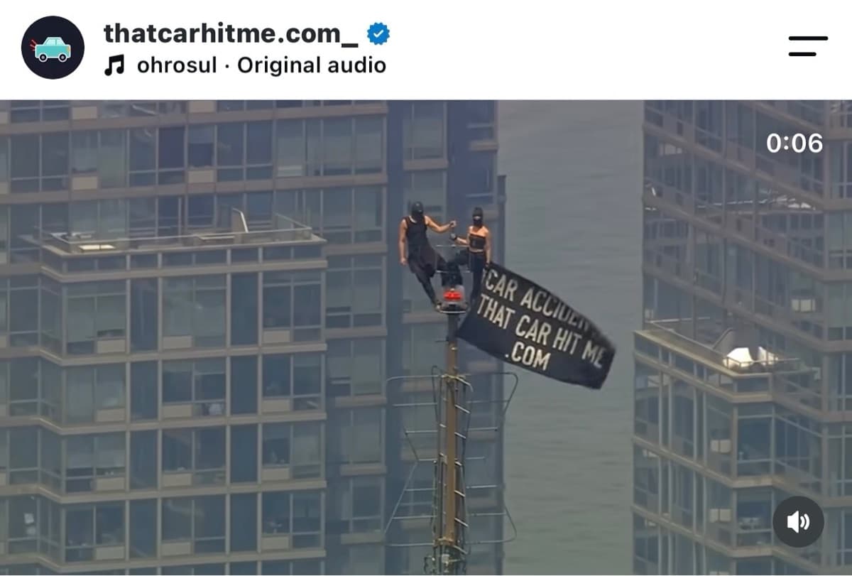 Viral flag trend video: a CAR ACCIDENT? THATCARHITME.COM flag flown from a skyscraper antenna
